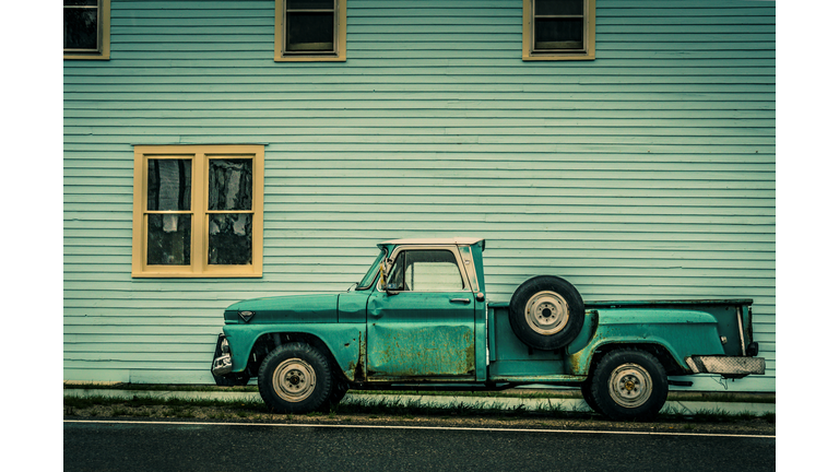 Old Green Truck against Green Building