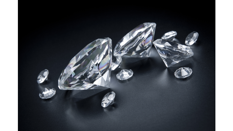 Few, huge diamonds scattered on black background