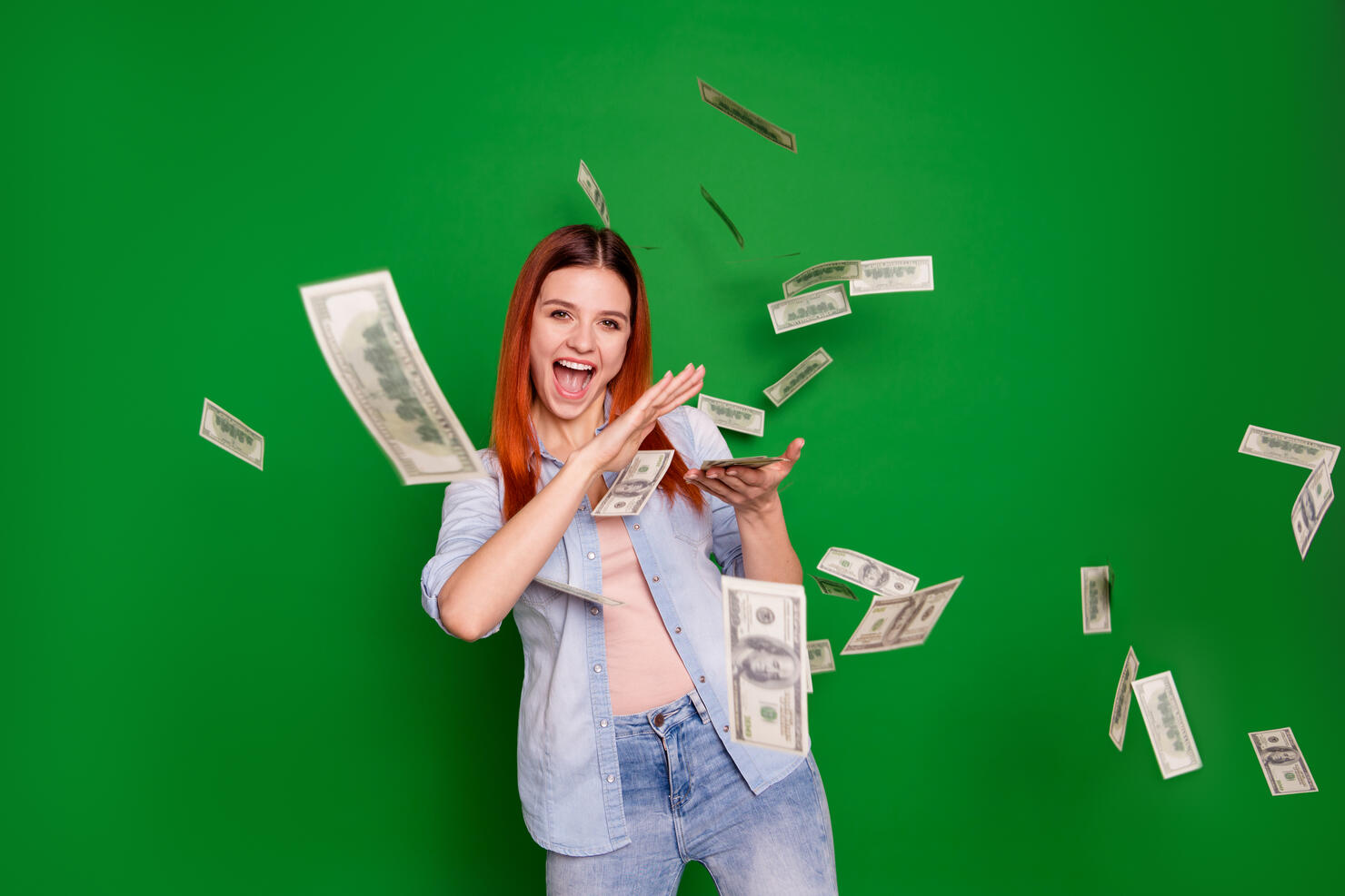 Portrait delighted ecstatic lady hold hand get salary wages rich aim positive cheerful satisfied content beautiful trendy stylish wear jeans long straight hairstyle isolated on green background
