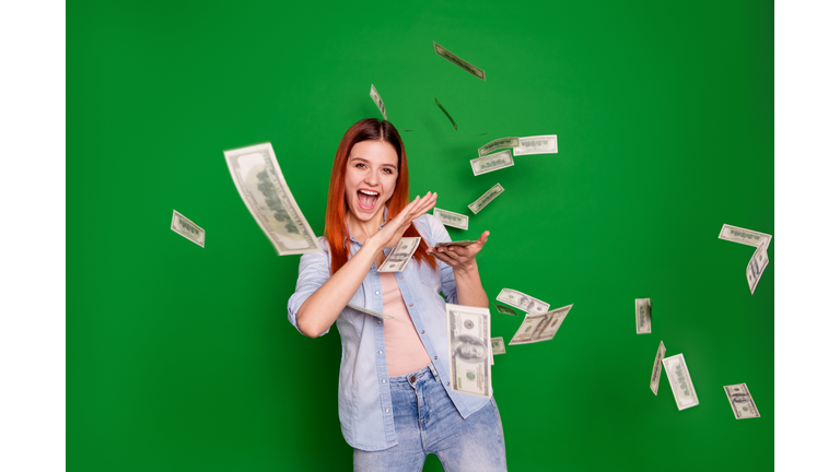 Portrait delighted ecstatic lady hold hand get salary wages rich aim positive cheerful satisfied content beautiful trendy stylish wear jeans long straight hairstyle isolated on green background
