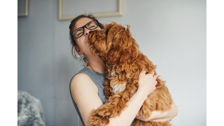 Woman holding her pet dog