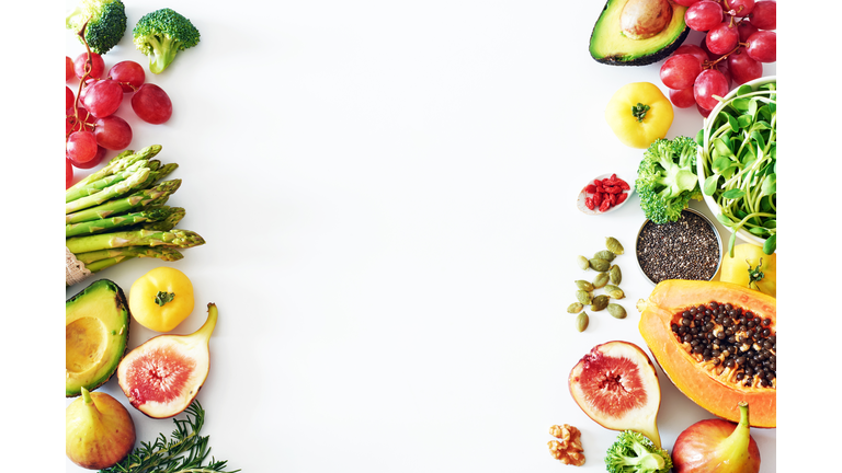 Fresh veggies and fruits food frame on white background with copy space.