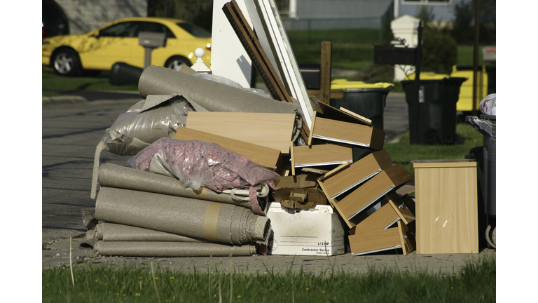 A pile of trash sitting on a curb