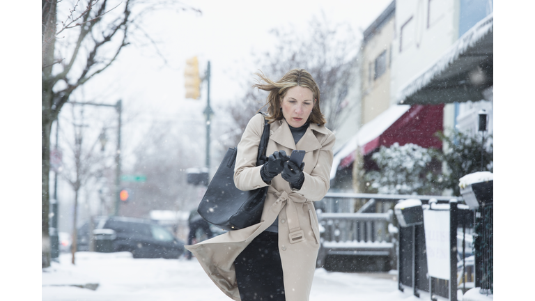 Woman walking on snowy street