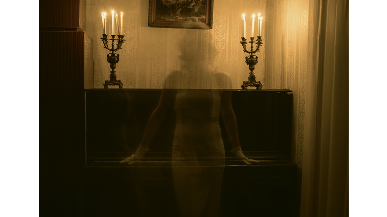 Female Ghost Against Piano In Darkroom