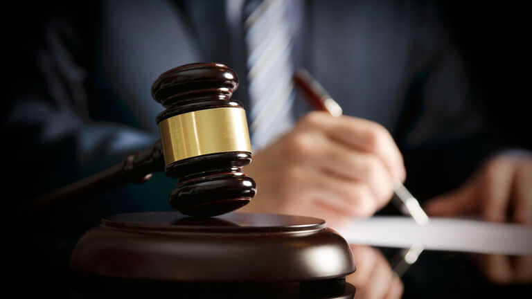 Lawyer in office with gavel, symbol of justice