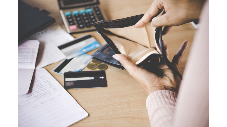 woman hand open empty purse looking for money having problem bankrupt broke