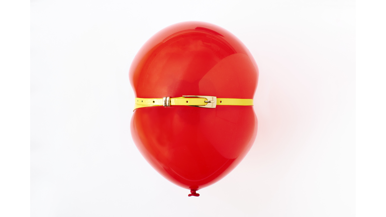 Red balloon, conceptual image of bloated stomach