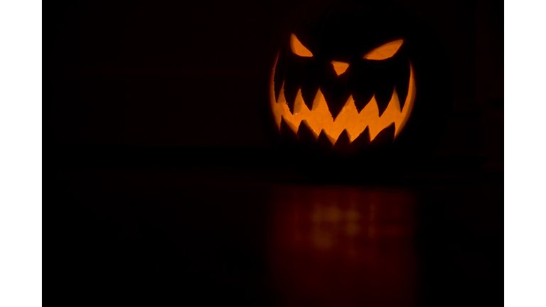 Scary Jack O Lantern on orange on black background