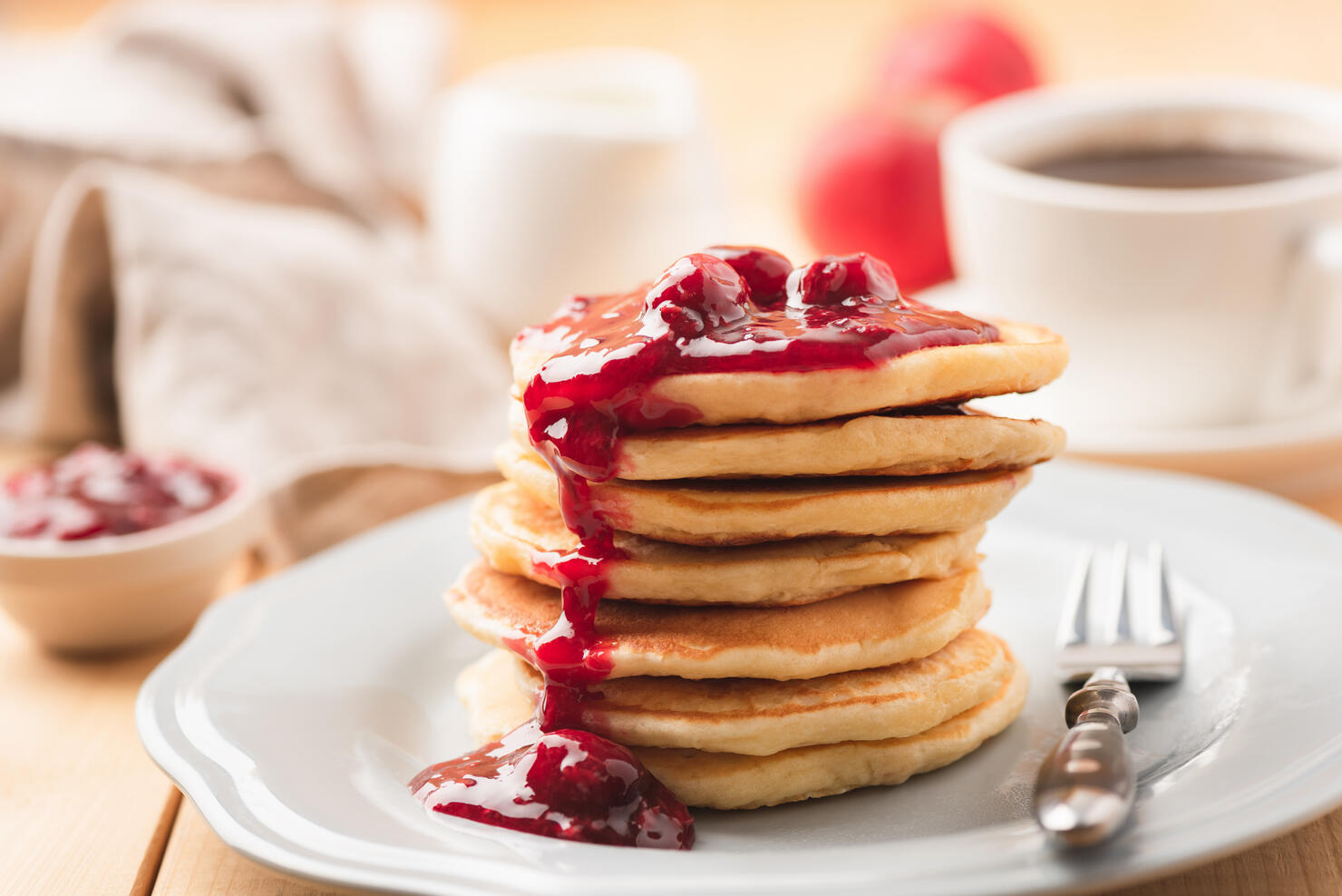 Pancakes with berry sauce and coffee breakfast