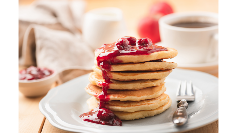 Pancakes with berry sauce and coffee breakfast
