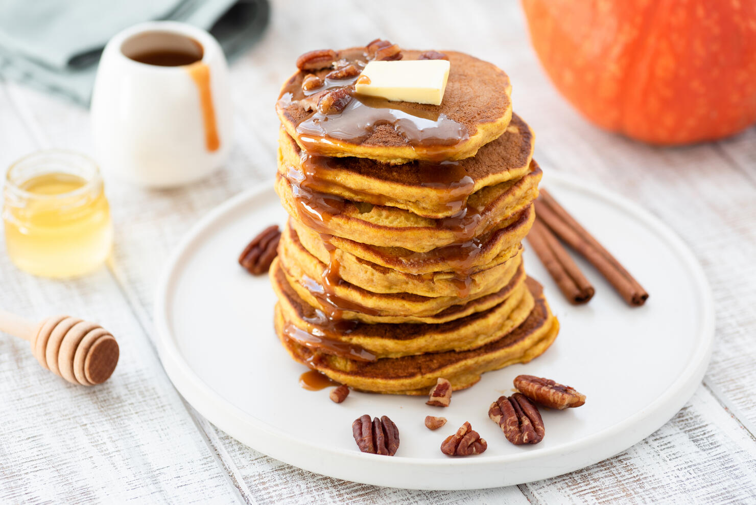 Pumpkin spice pancakes stack on white plate