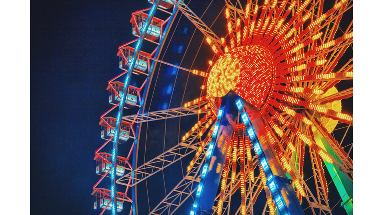 Low Angle View Of Illuminated Ferris Wheel Against Sky At Night