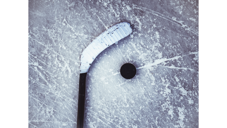 hockey puck and stick on the ice texture background