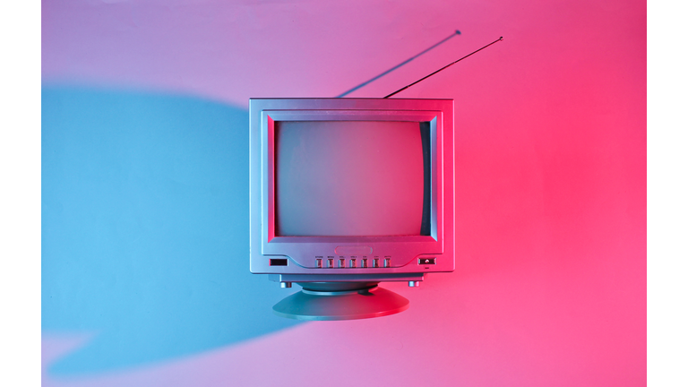 Retro wave, 80s. Old tv with antenna with neon light. Top view, minimalism