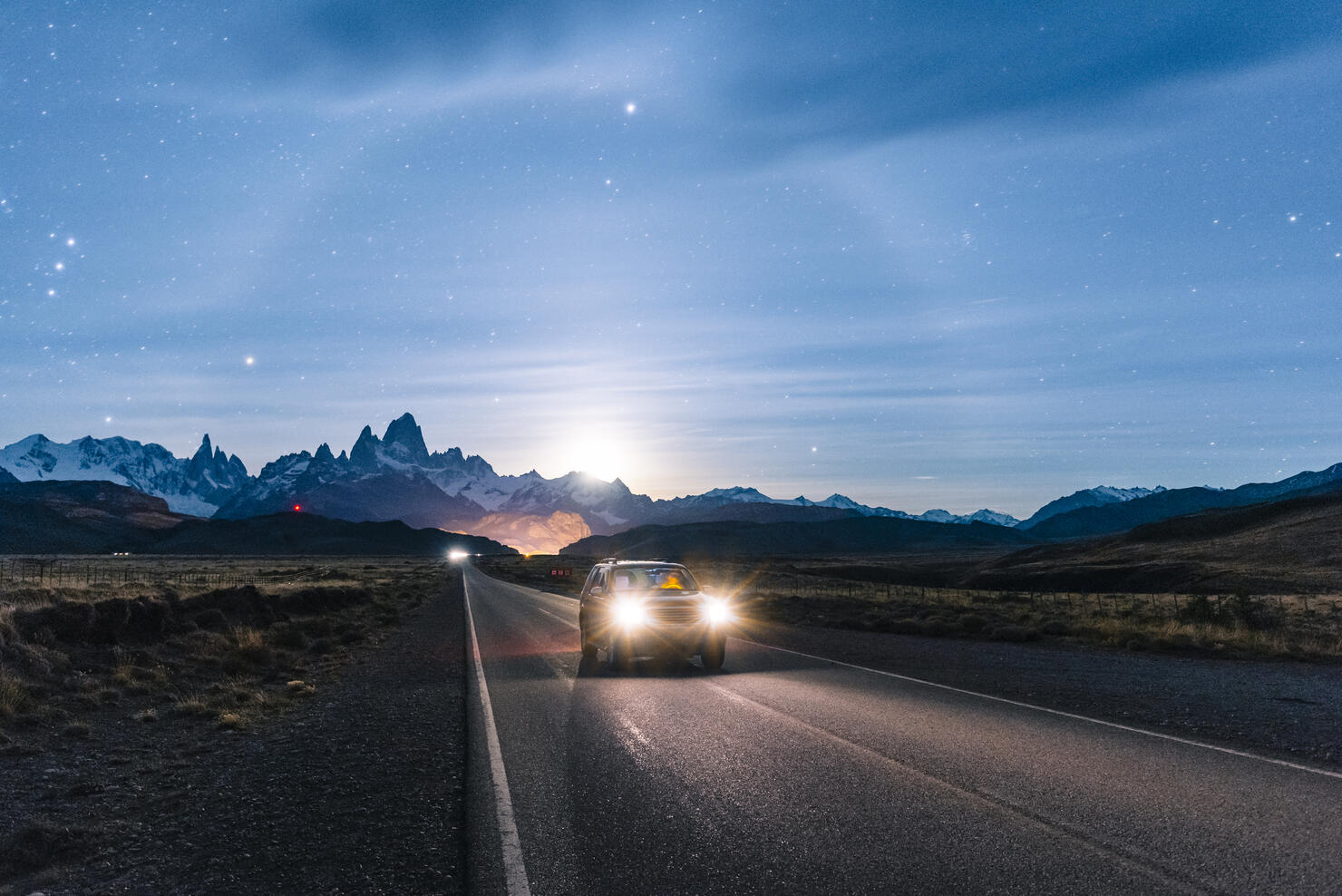 Car driving at night on the road to El Chalten, Patagonia Argentina