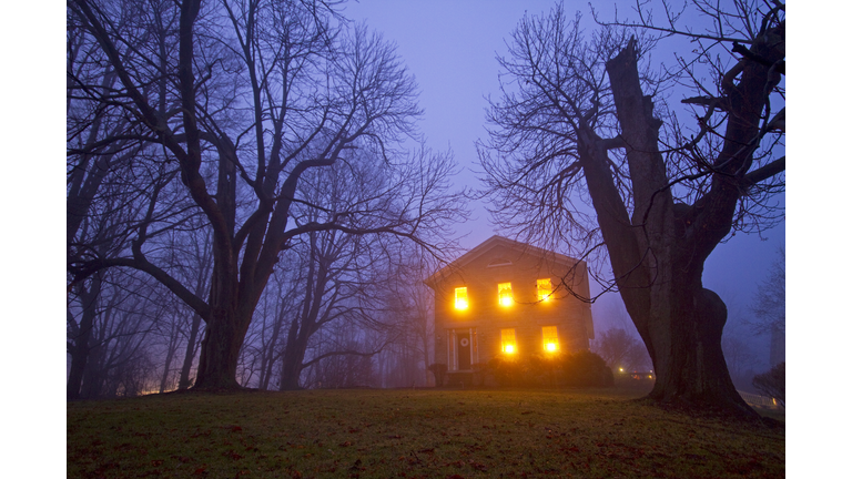 Old stone house on foggy night