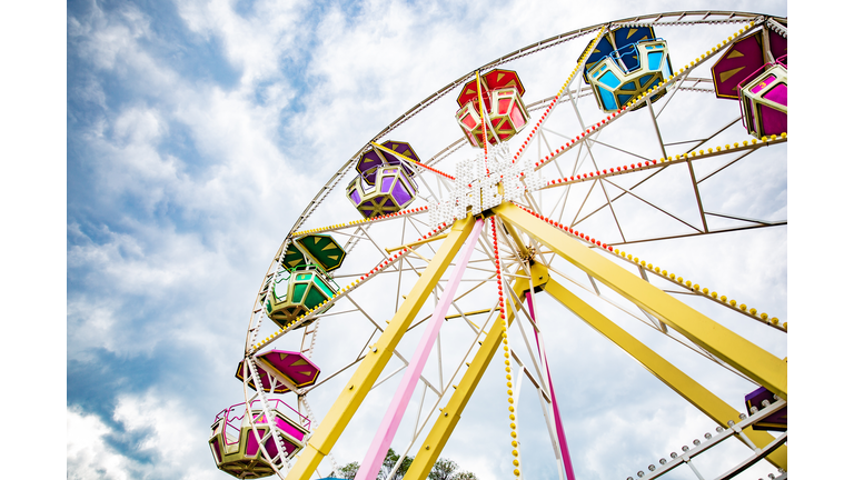 Multicolour ferris wheel on blue sky background