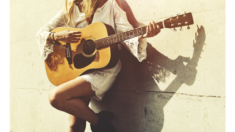 Girl Playing Guitar Writing Song Concept