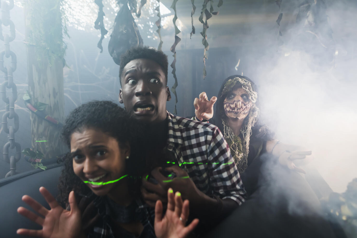 Young couple with zombie in halloween haunted house