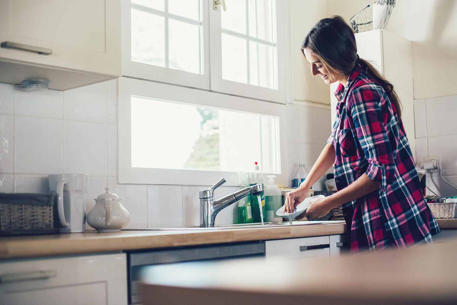 Housewife washing dishes
