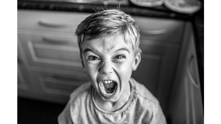 Portrait Of Boy Screaming At Home