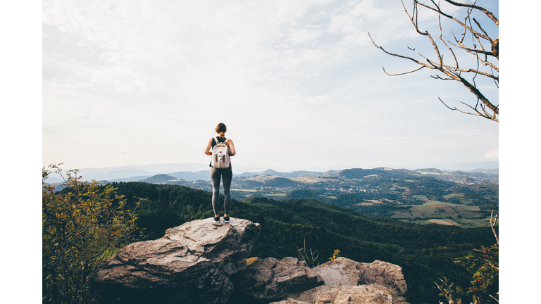 Rear View Of Woman Standing On Cliff