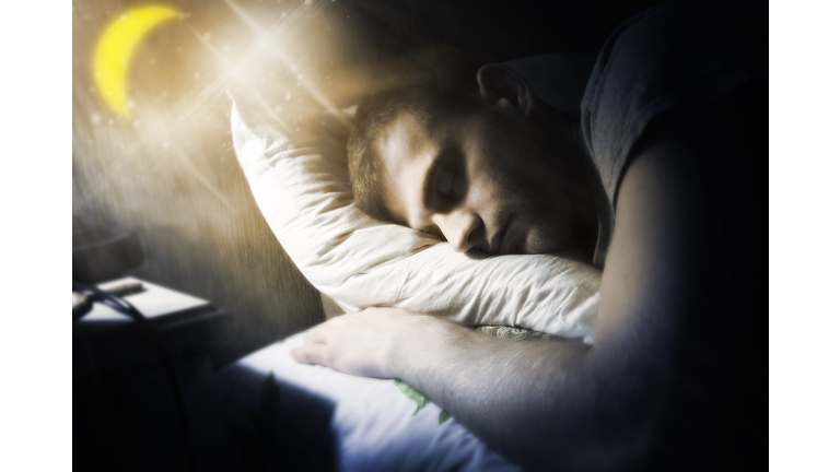a man sleeps under the moon and sees beautiful dreams