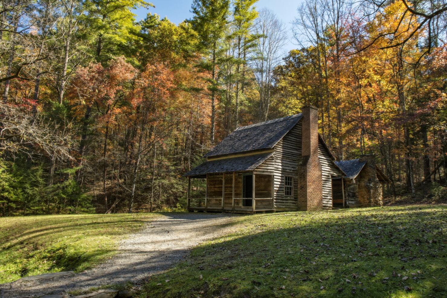 The Henry Whitehead homestead located in Cades Cove in the Great Smoky Mountains National Park is surrounded by colorful fall foliage.