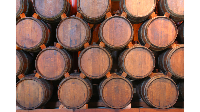 Oak Wine Barrels Stacked in Winery Cellar, Napa Valley, California
