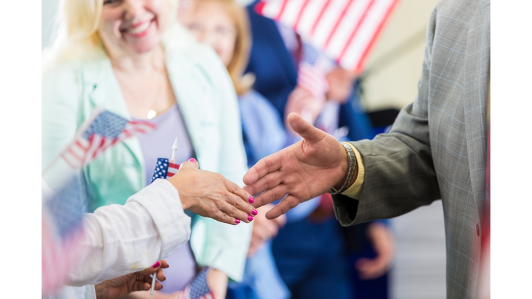 Political candidate greets supporters during rally