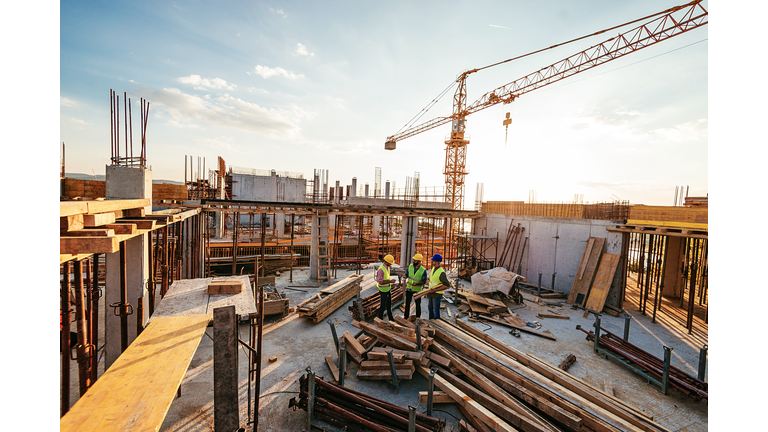 Investors and contractors on construction site