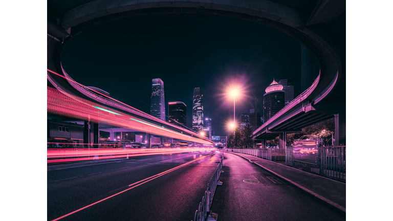 Light trails at night on a main street in Beijing.