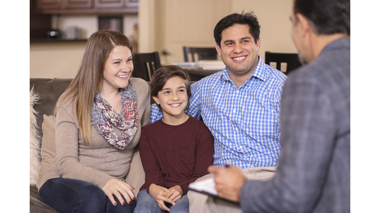 Family counseling session at home with therapist.