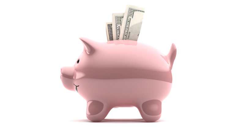 Large pink piggy bank filled with notes