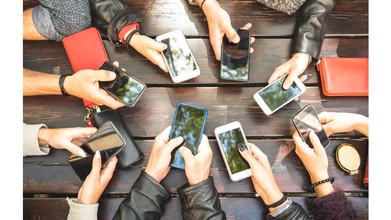 People group having addicted fun together using smartphones - Detail of hands sharing content on social network with mobile smart phones - Technology concept with millennials online with cellphones