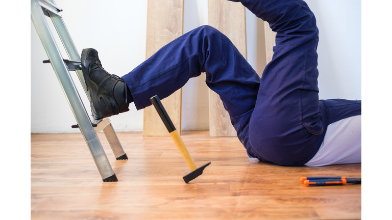 Construction worker falling down the ladder