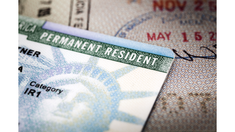 A Green Card lying on an open passport, close-up, full frame