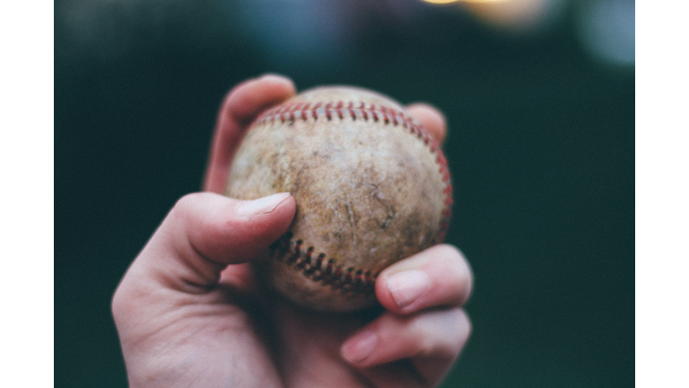 Hand holding baseball