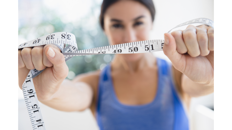 Woman holding measuring tape