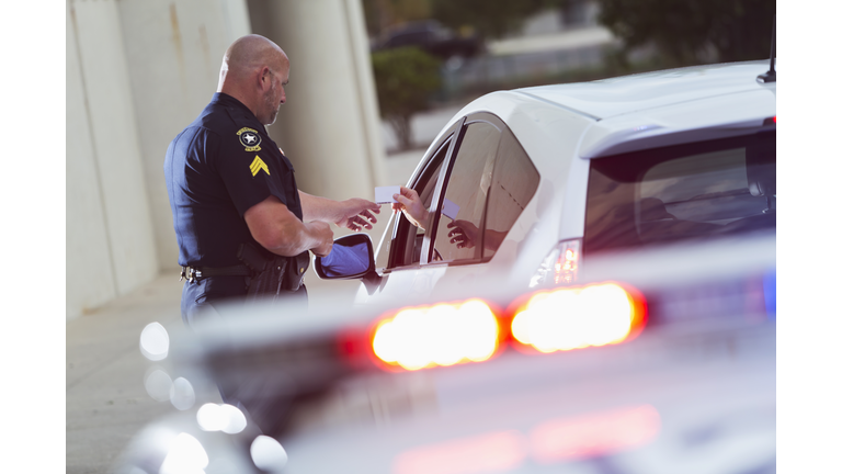 Policeman asking a driver for identification