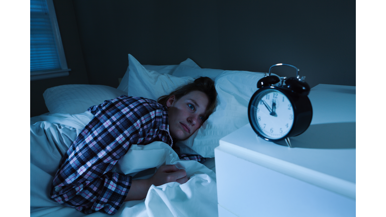 Sleepless Young Woman with Insomnia in Bed, Watching Alarm Clock