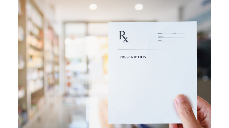 Pharmacist hold blank prescription in pharmacy store