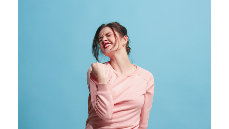 Winning success woman happy ecstatic celebrating being a winner. Dynamic energetic image of female model