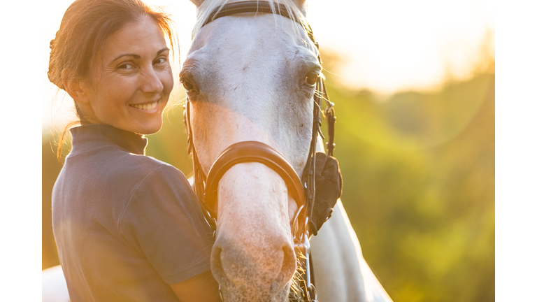 Woman hugging her horse