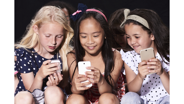 Group of friends using their phones