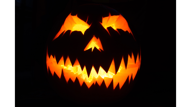 Close-Up Of Illuminated Pumpkin Against Black Background