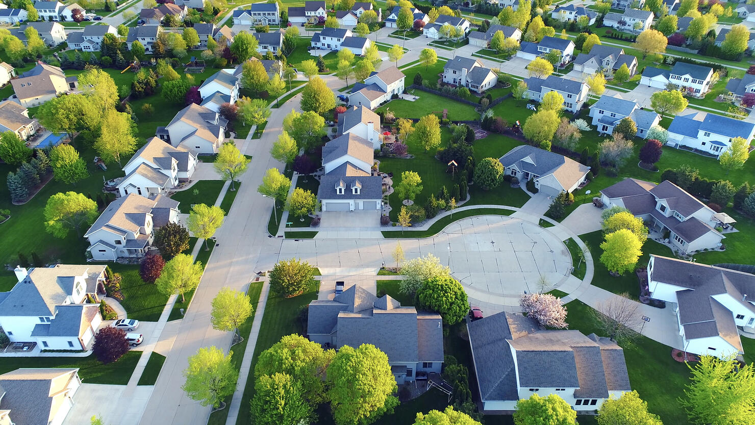 Perfect neighborhoods, homes, Springtime aerial view at sunrise.