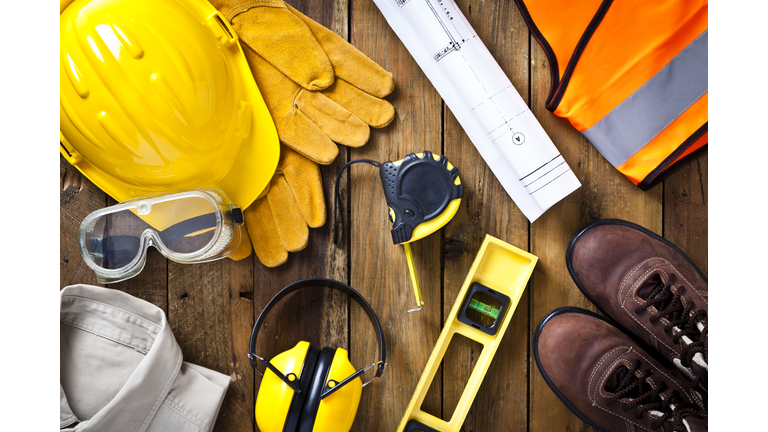 Personal safety workwear and construction blueprint shot directly above