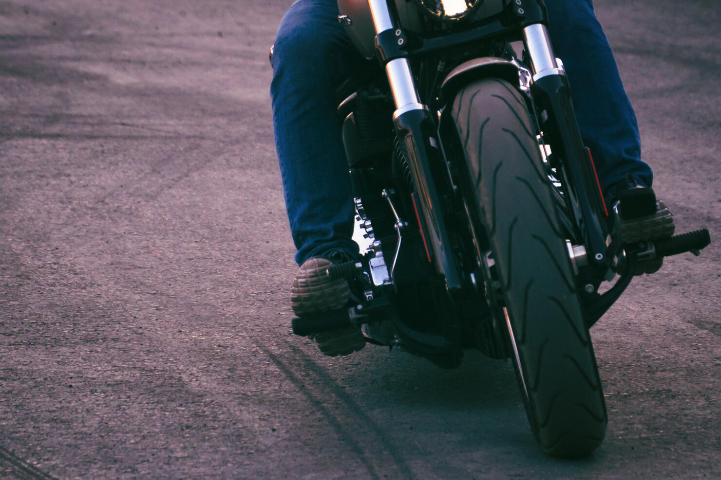 Biker iriding a motorcycle. Front view